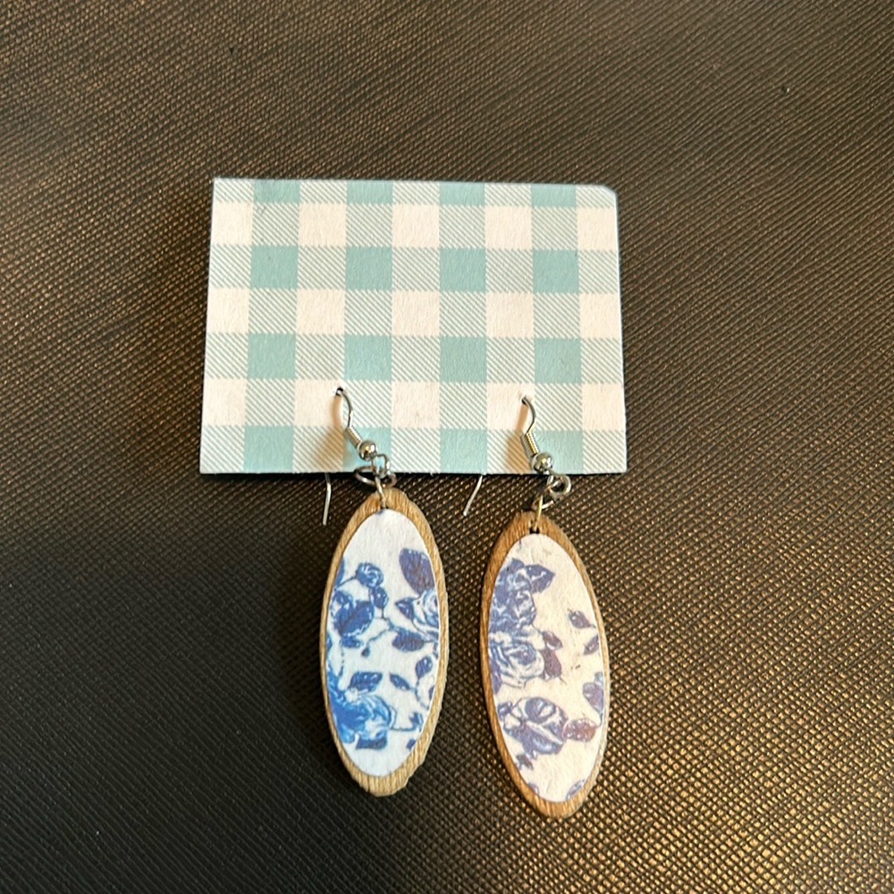 Handmade wood earrings blue and white flowers on wood border.